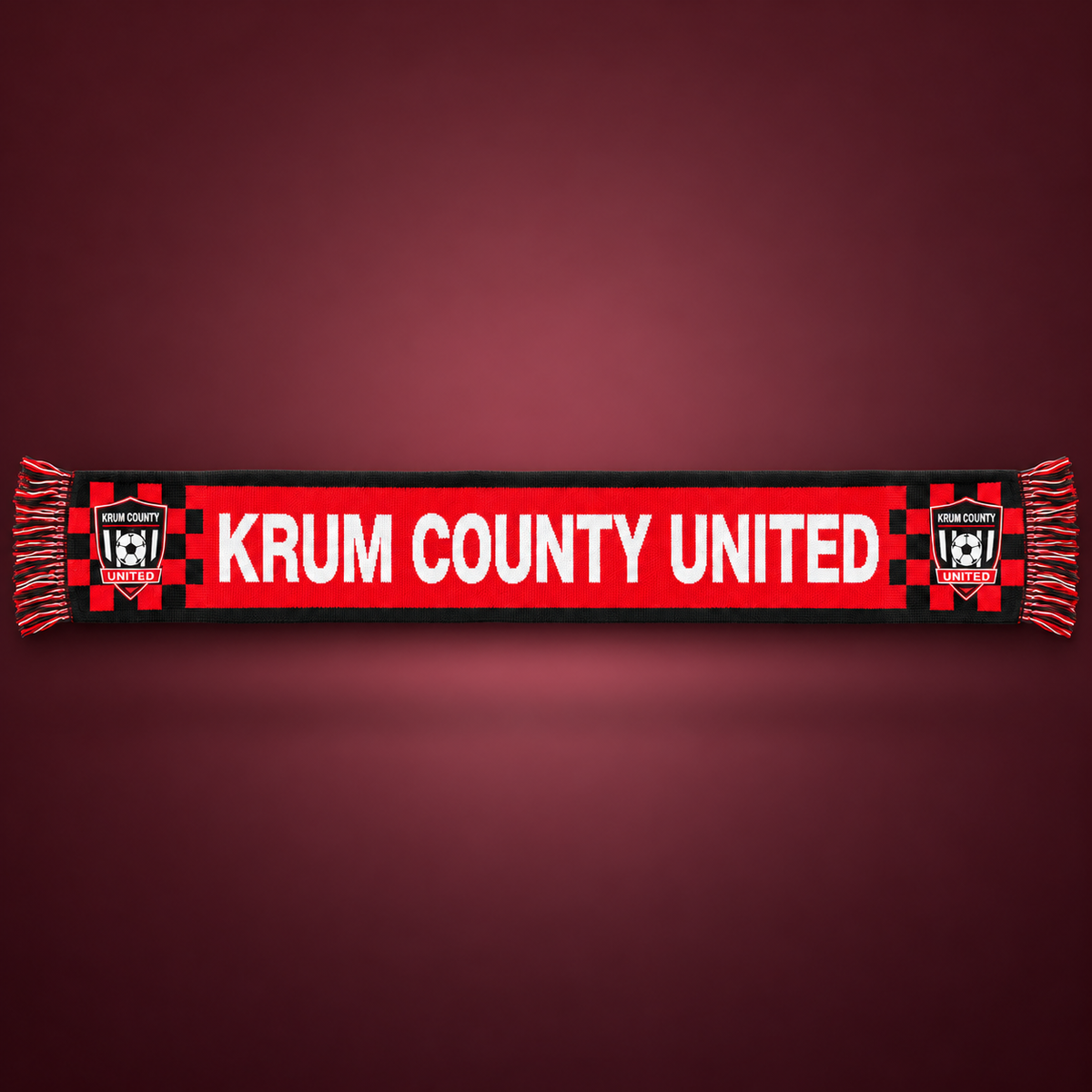 Red and black Krum County United supporter scarf with white club lettering, crest ends, and fringe.