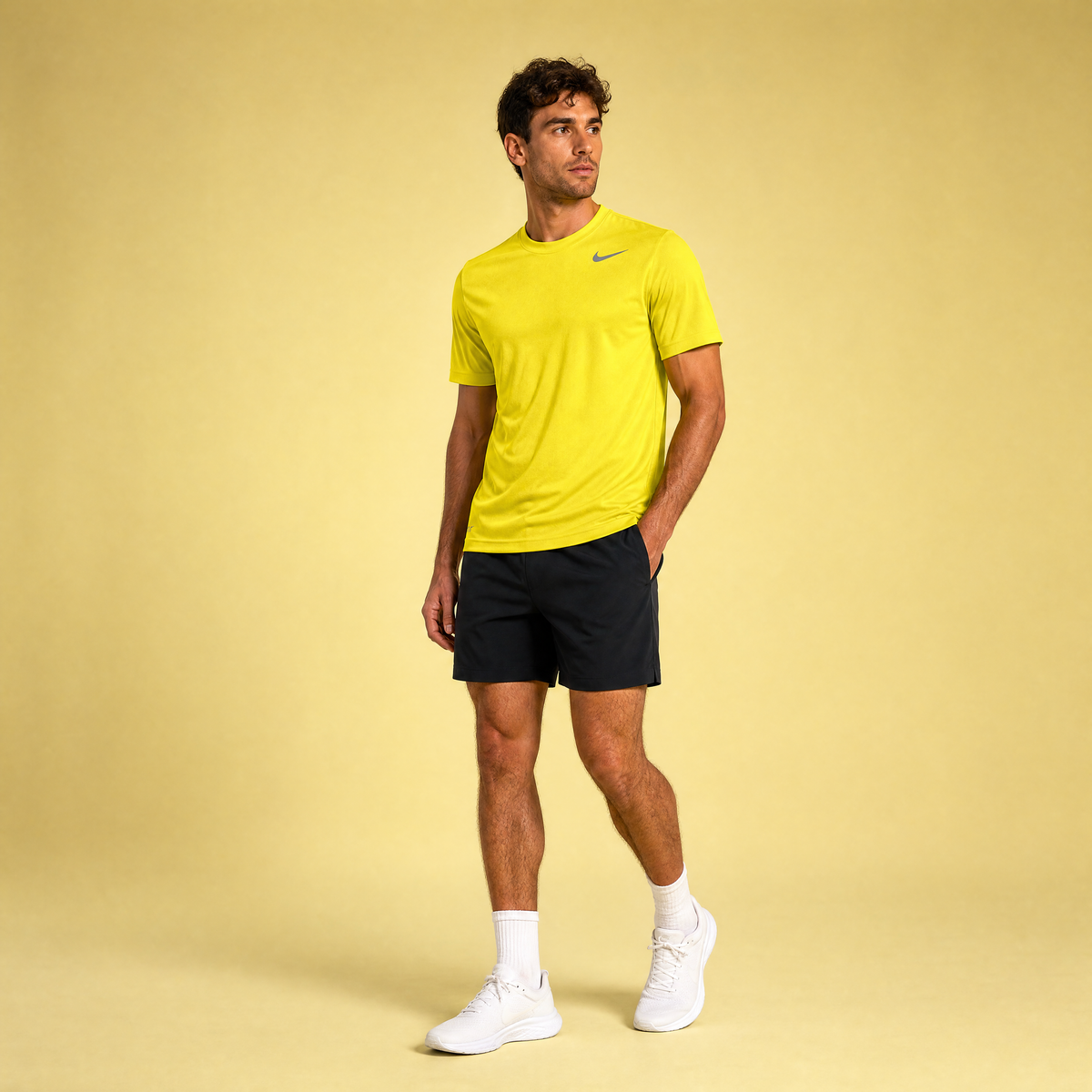 Male athlete modeling the neon yellow Nike Short Sleeve Dri-FIT Athletic Shirt