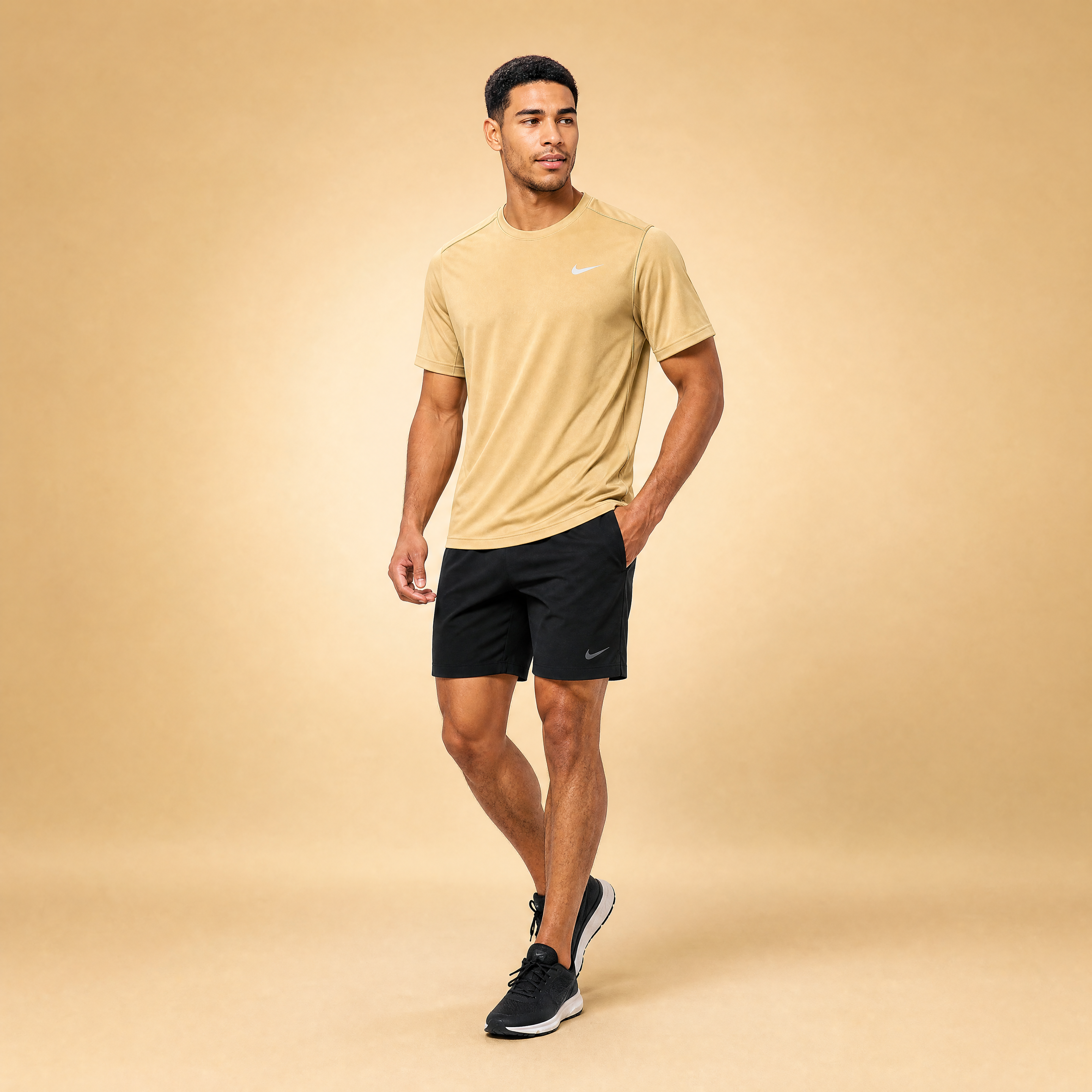 Male athlete modeling the tan Nike Short Sleeve Dri-FIT Athletic Shirt