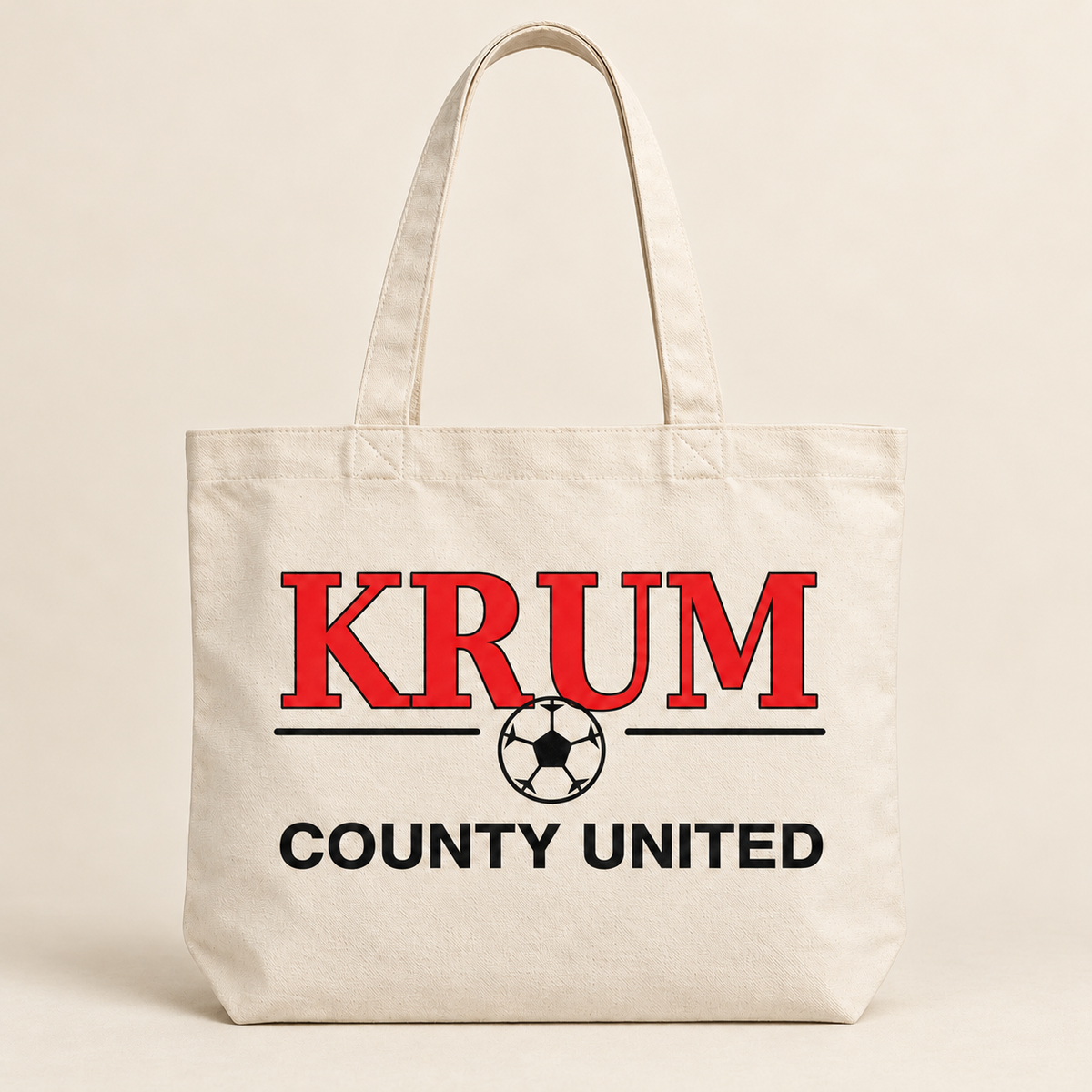 Natural tote bag with long handles, red KRUM lettering, and a black County United soccer graphic.