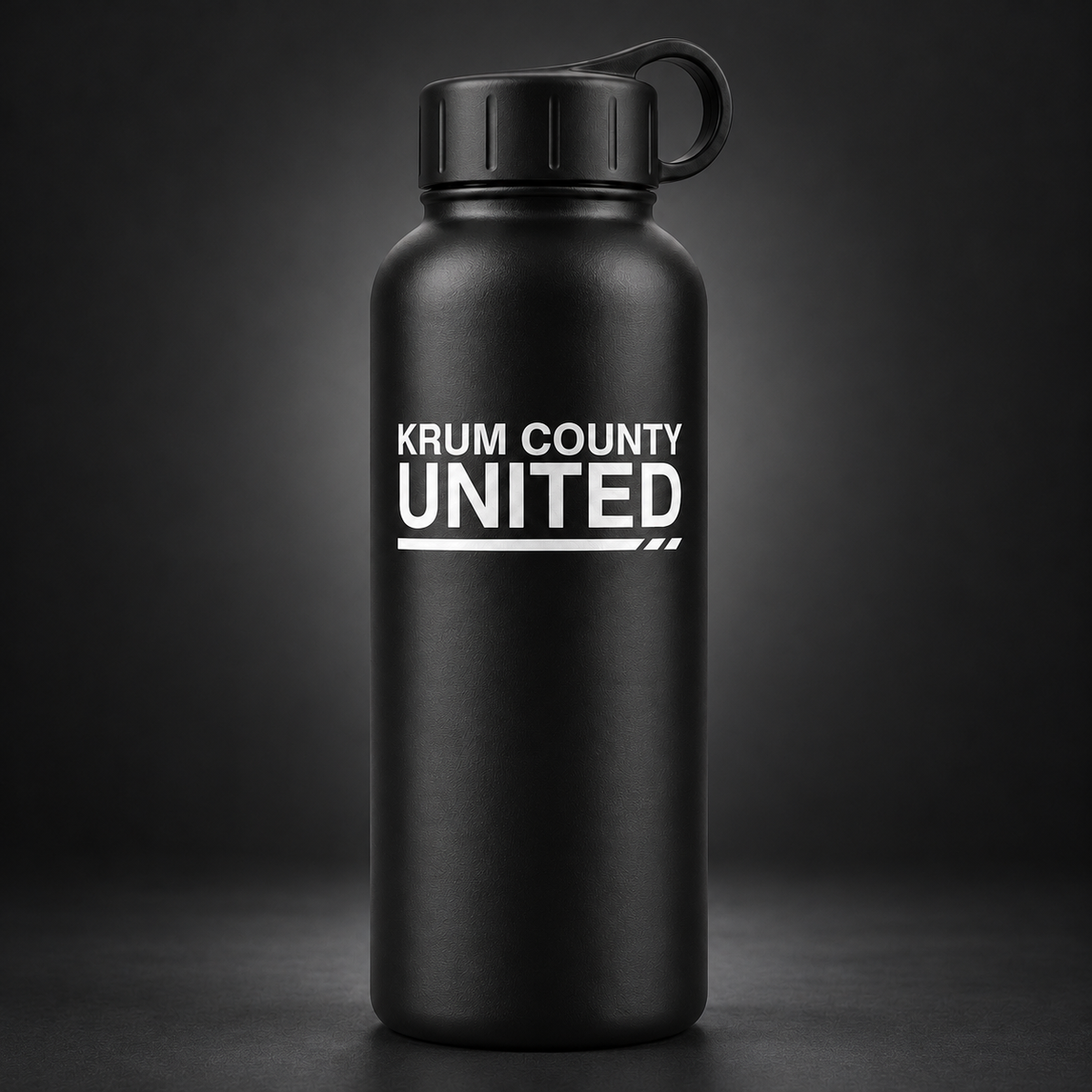 Matte-black water bottle with a carry-loop lid and white Krum County United wordmark on the front.